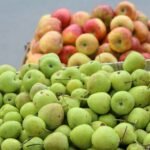 green and red apples on stainless steel rack